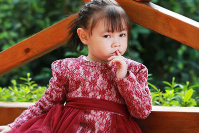 Portrait of cute girl against railing