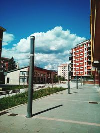 Buildings in city against cloudy sky