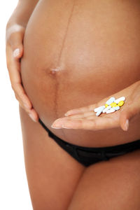 Close-up of woman holding hands over white background