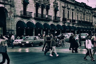 People on sidewalk in city