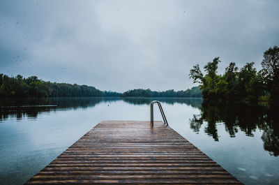 Pier over lake against clear sky