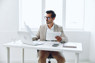 Businesswoman using laptop at desk in office