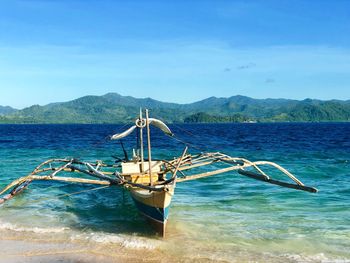 Fishing boat in sea against sky