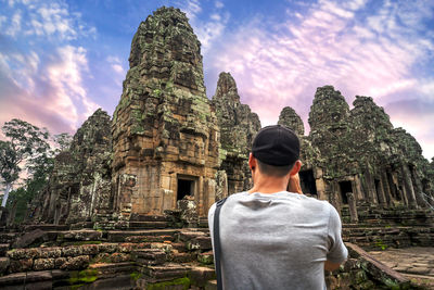 Rear view of man in temple against sky