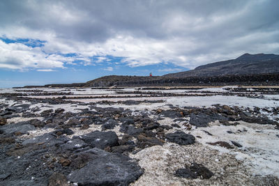 Scenic view of salt pans against sky