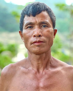 Portrait of young man against trees