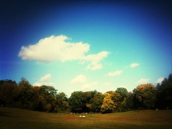 Scenic view of field against cloudy sky