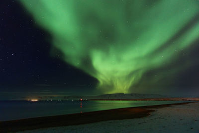 Scenic view of sea against sky at night