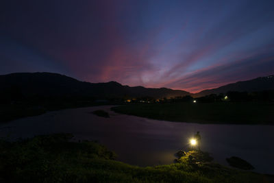 The evening landscape, the river, the mountains, the dark blue sky, and my shadow