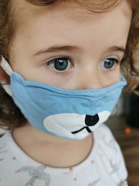 Close of little brazilian girl using mask on quarantine.