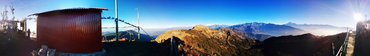 Panoramic view of mountains against clear blue sky