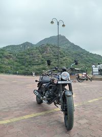People riding motorcycle on road against sky