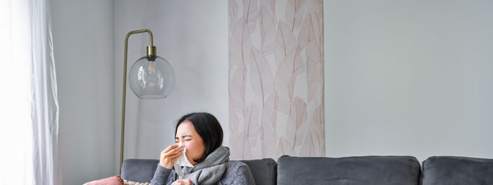 Portrait of young woman sitting at home