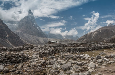 Scenic view of mountains against cloudy sky