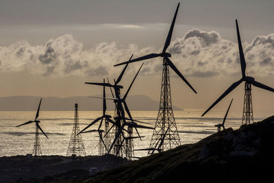 Low angle view of traditional windmill on field against sky