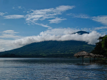 Scenic view of sea and mountains against sky