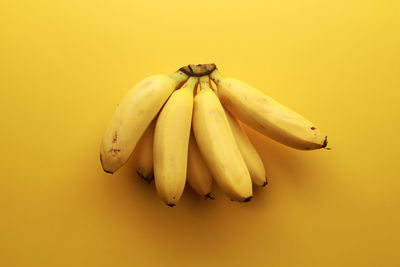 Close-up of fruit against yellow background