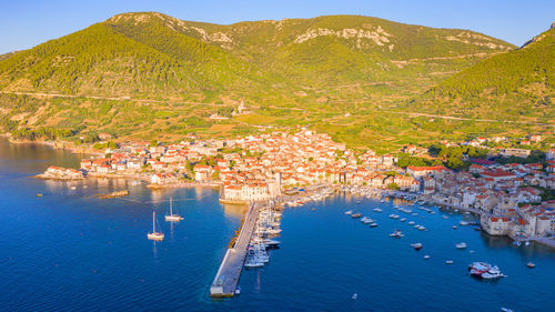 High angle view of harbor by sea against mountains