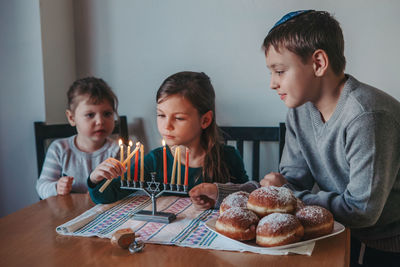 High angle view of people looking at camera on table