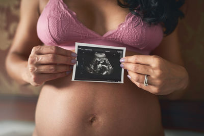 Midsection of woman using mobile phone