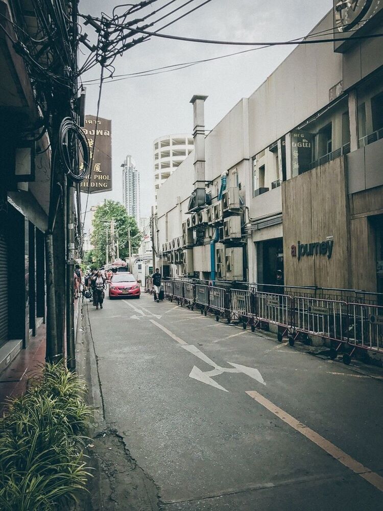 CARS ON ROAD AGAINST BUILDINGS IN CITY