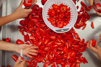 High angle view of hand holding red chili peppers