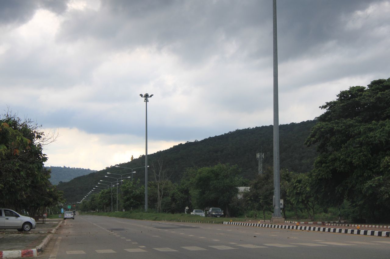 CARS ON ROAD AGAINST SKY