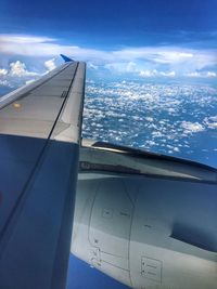 Close-up of airplane wing over sea