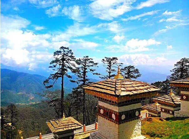 building exterior, architecture, built structure, sky, tree, cloud - sky, cloud, mountain, house, roof, low angle view, residential structure, day, residential building, cloudy, blue, outdoors, travel destinations, no people, sunlight