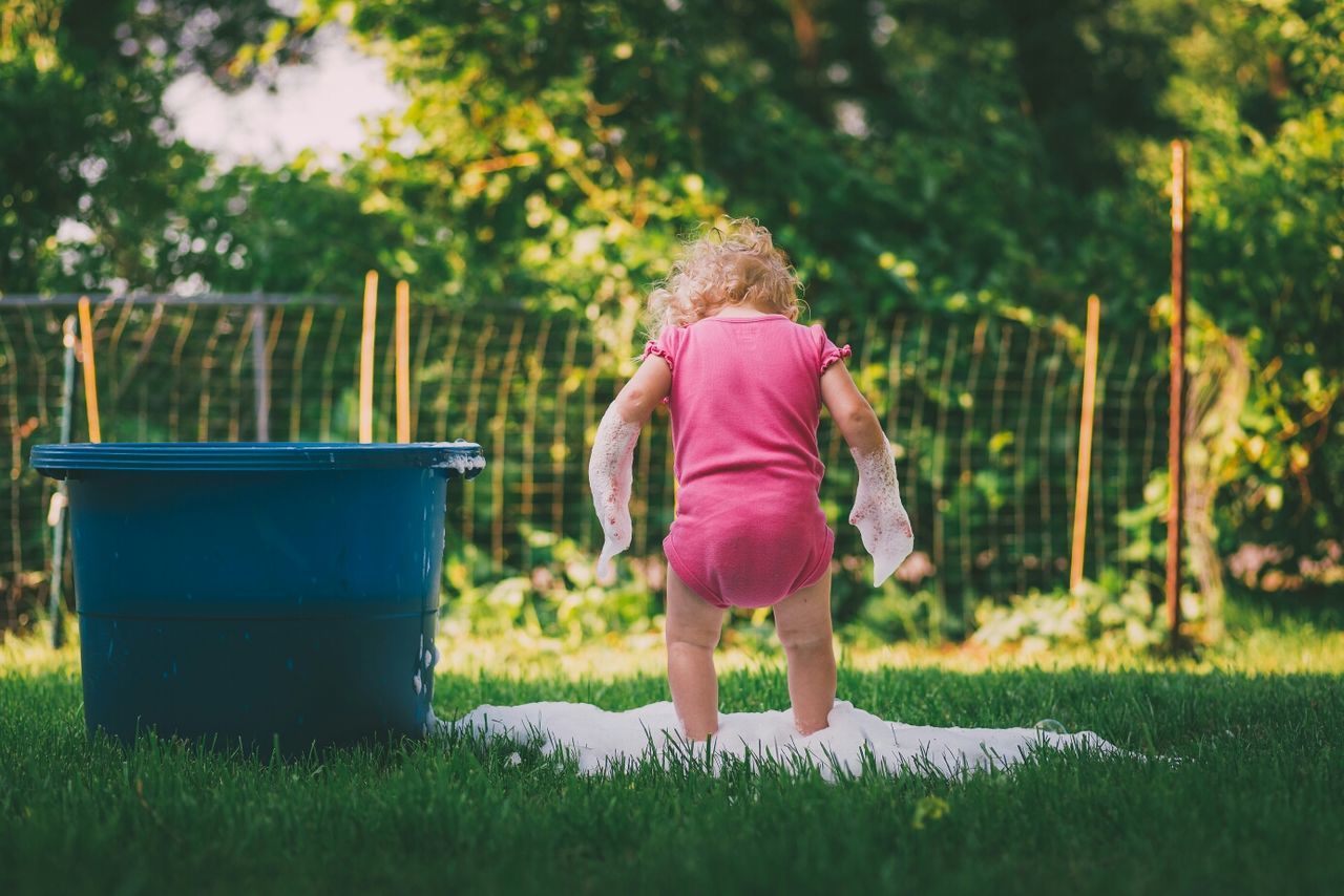 childhood, grass, elementary age, girls, full length, park - man made space, casual clothing, leisure activity, lifestyles, boys, field, rear view, innocence, grassy, focus on foreground, tree, green color, playing