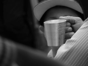 Close-up of hand holding coffee cup