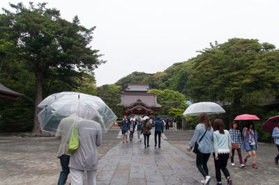 Tourists visiting tsurugaoka hachimangu during rainy season