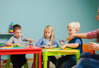 Rear view of people sitting on table