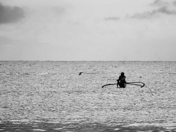 Silhouette of person in sea