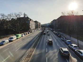 Traffic on road in city against sky