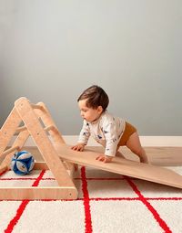 Side view of young woman sitting on table