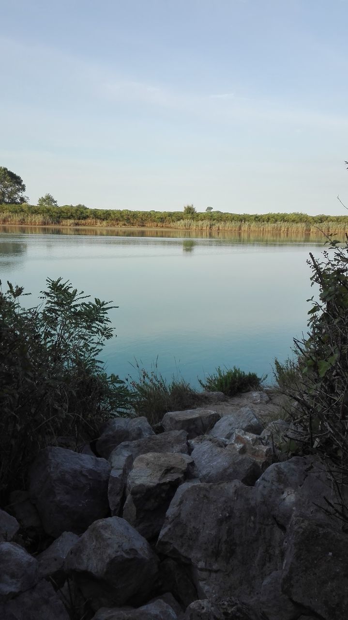 water, nature, sky, tranquil scene, tranquility, beauty in nature, scenics, outdoors, reflection, no people, lake, tree, day, landscape