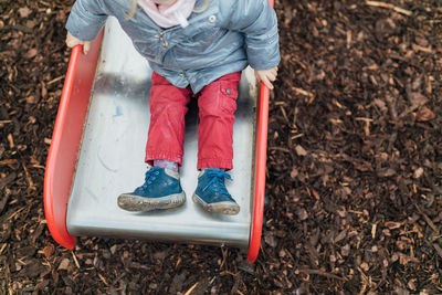 Low section of child playing in playground