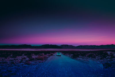 Car moving on dirt road during dusk