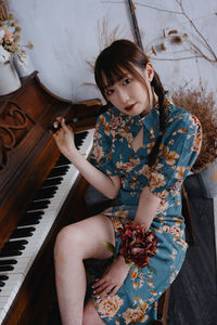 Portrait of young woman playing piano