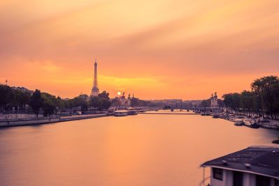 Scenic view of river against sky during sunset