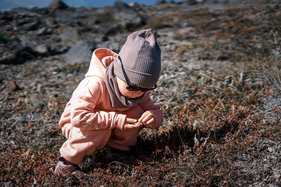 Midsection of girl wearing hat on land