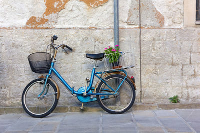 Bicycle parked against wall