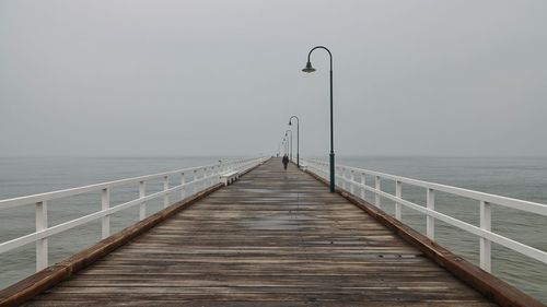 View of pier on sea against sky