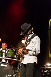 People playing guitar at music concert