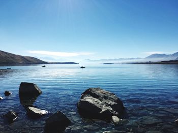 Scenic view of sea against clear blue sky