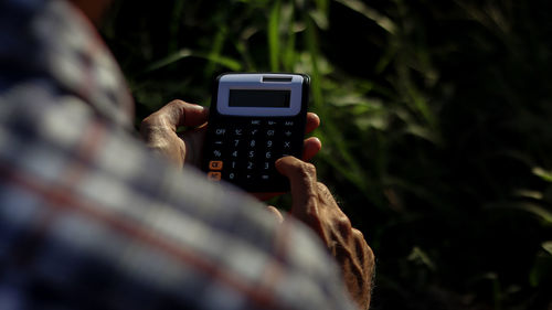 Close-up of person photographing smart phone outdoors