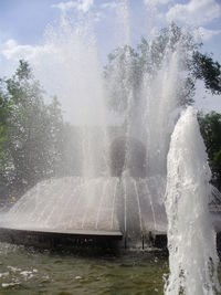 Water splashing in fountain against sky