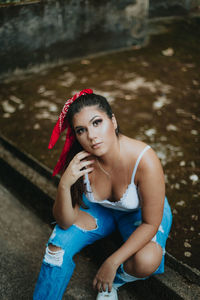 Portrait of young woman sitting outdoors