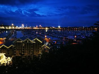 High angle view of illuminated buildings against sky at night